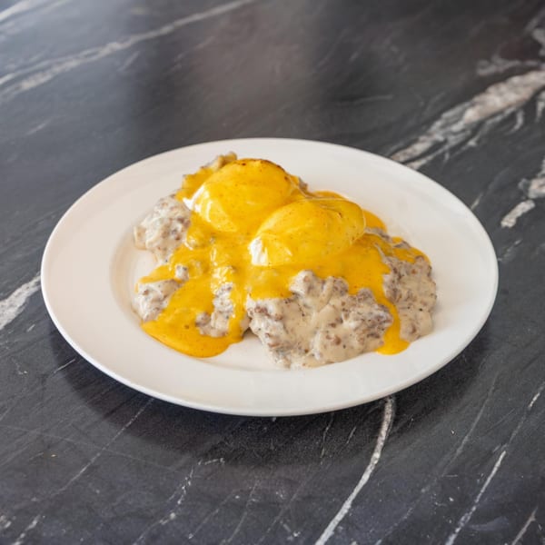 Bell the Cat's biscuits and gravy topped with two poached eggs and hollandaise sauce.