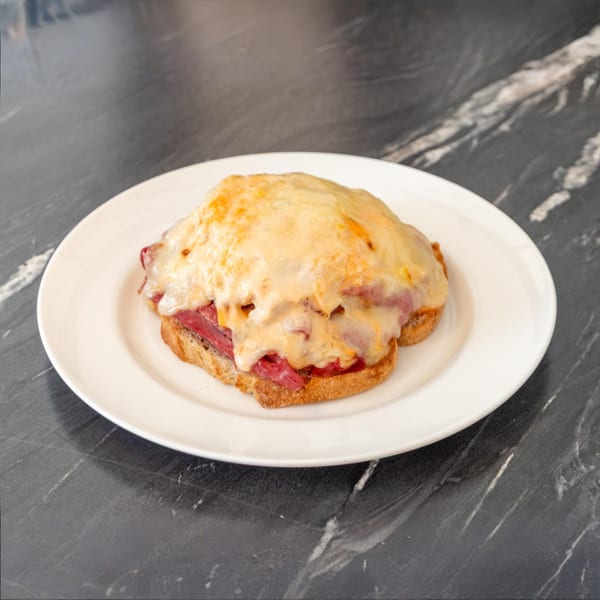 Bell the Cat's open-faced sandwich with melted cheese and pastrami on toasted bread.